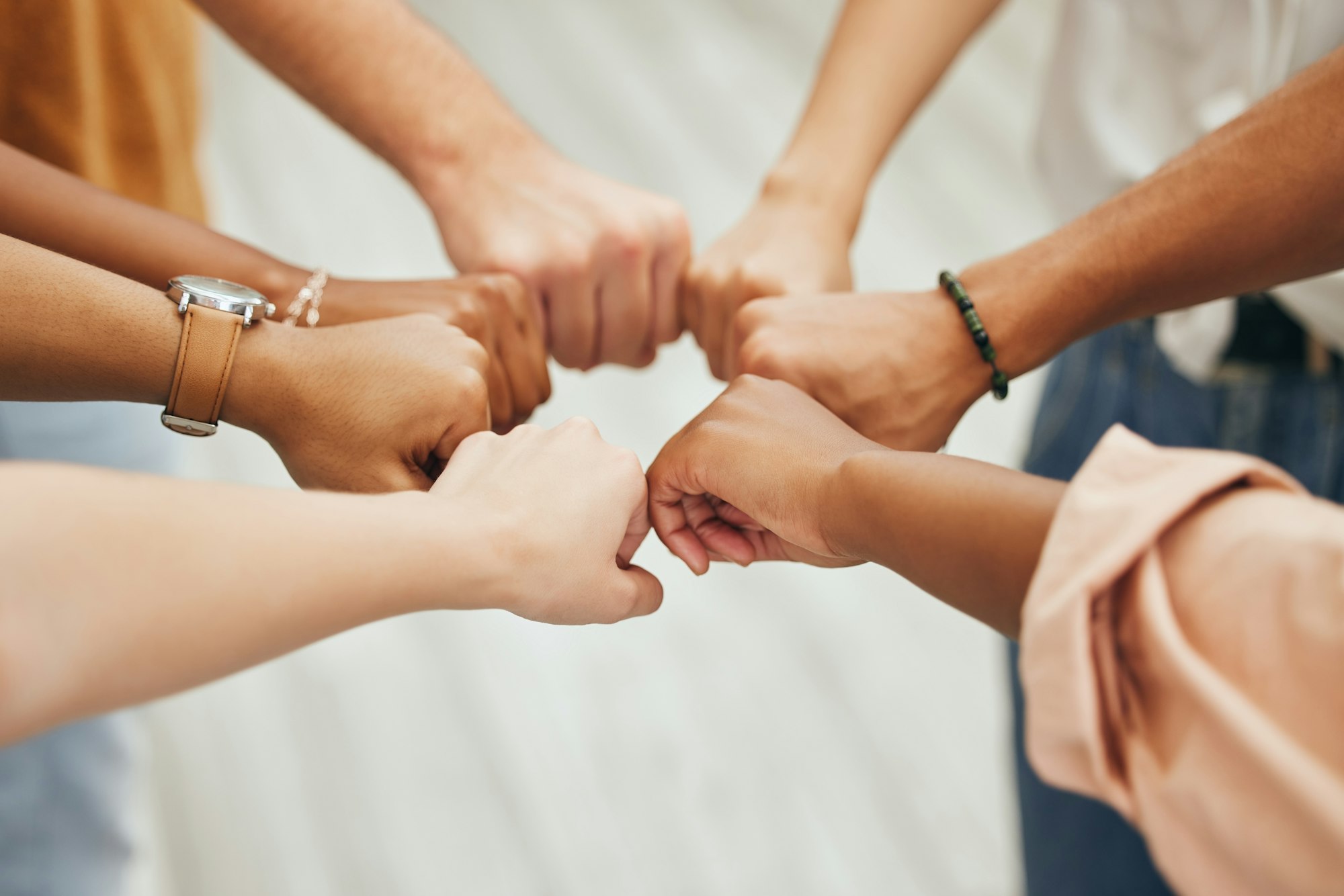 Fist bump, hands and teamwork support hand sign showing community, team building and goal success.